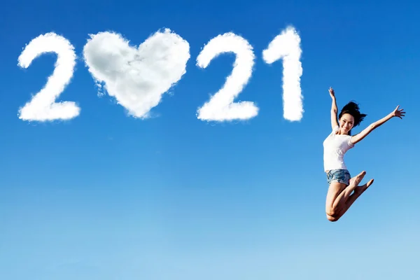 Cheerful Woman Jumping Clouds Shaped 2021 Numbers Heart Symbol Blue — Stock Photo, Image