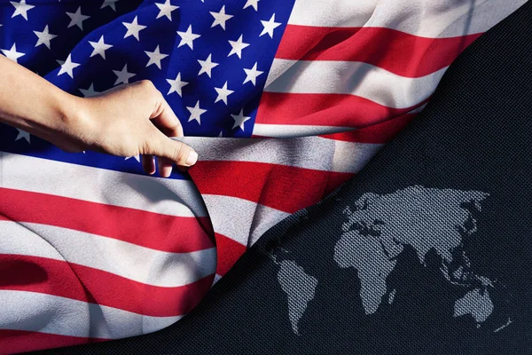 Close Van Hand Houden Van Een Amerikaanse Vlag Met Wereldkaart — Stockfoto