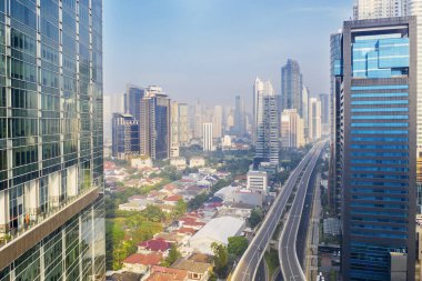 JAKARTA - Indonesia. June 29, 2021: Beautiful aerial view of highrise buildings with quiet overpass road in Jakarta downtown