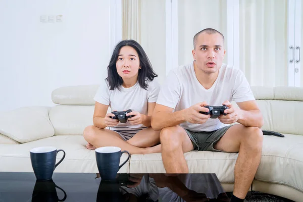 Happy Young Couple Sitting Sofa While Playing Video Games Together — Stok fotoğraf