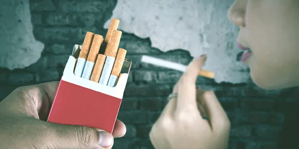 Close Young Woman Smoking Cigarette Offered Man Hand Broken Wall — Stok fotoğraf