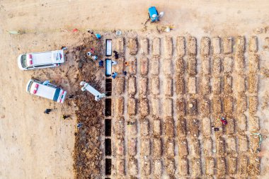 JAKARTA - Indonesia. July 26, 2021: Group of medical worker doing burial procession Covid-19 victims at Rorotan graveyard in North Jakarta, Indonesia