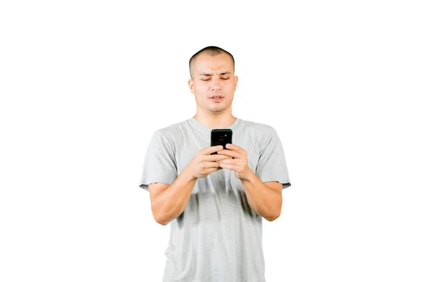 Caucasian Man Looks Confused While Using Cellphone Standing Studio Isolated — Stock fotografie