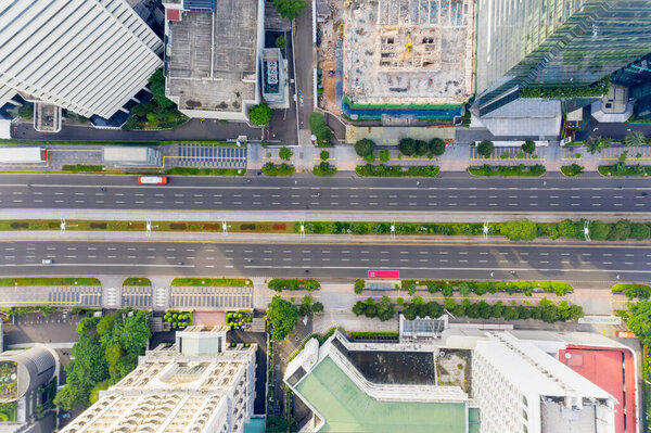 JAKARTA - Indonesia. July 27, 2021: Top down view of quiet traffic on the road due to implementing PPKM in Jakarta city with only public transportation are allowed to pass through