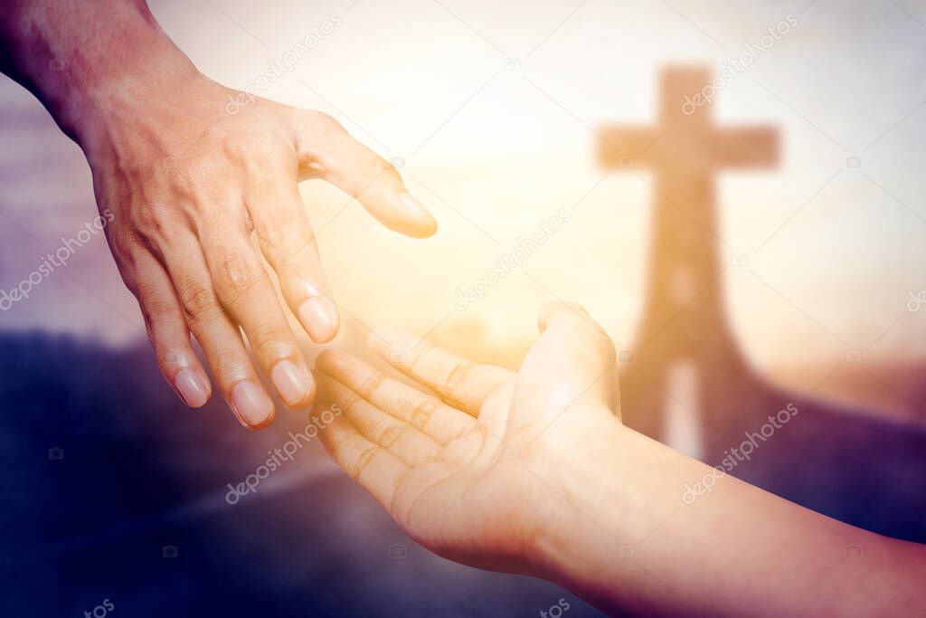 God salvation concept. Close up of God's hand reaching a human hand with Cross symbol on end of road