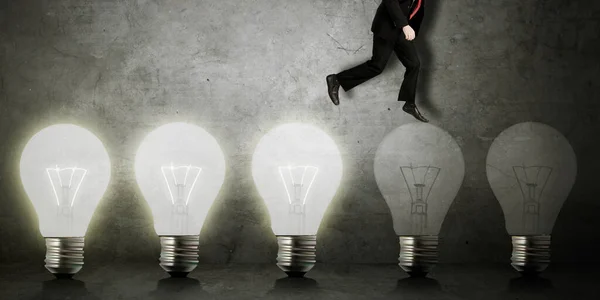 Close Businessman Walking Row Light Bulbs Concrete Wall Background — Stock Photo, Image