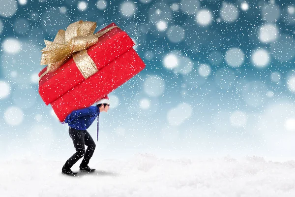 Young Businessman Carrying Big Christmas Present While Walking Snowy Park — Stock Photo, Image