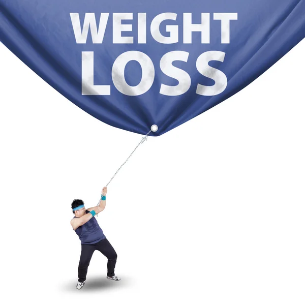 Man pulling weight loss banner — Stock Photo, Image