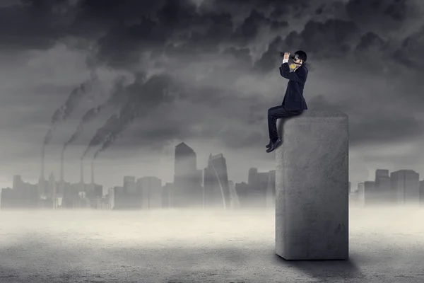 Businessman looking for a solution to pollution — Stock Photo, Image