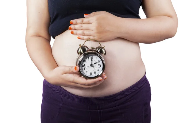 Zwangere vrouw met een wekker — Stockfoto