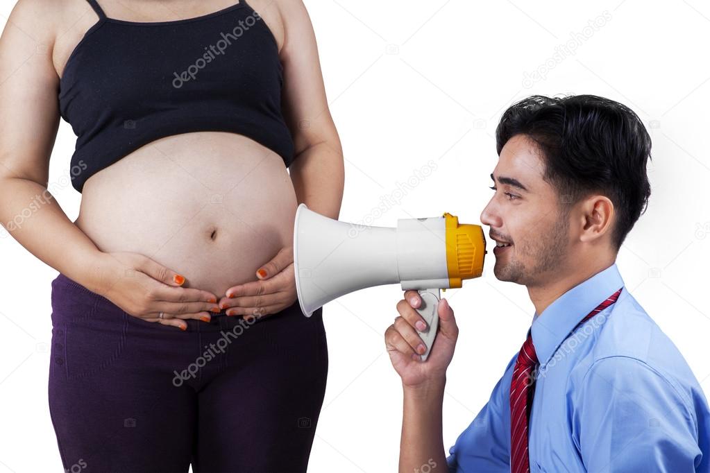 Husband speaking with wife belly 1