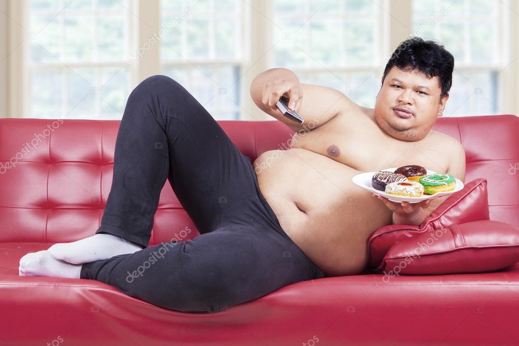 Person sitting on sofa with donuts