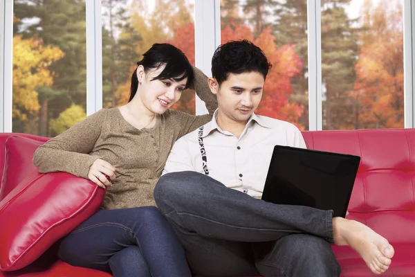 Couple using laptop at home in autumn — Stock Photo, Image