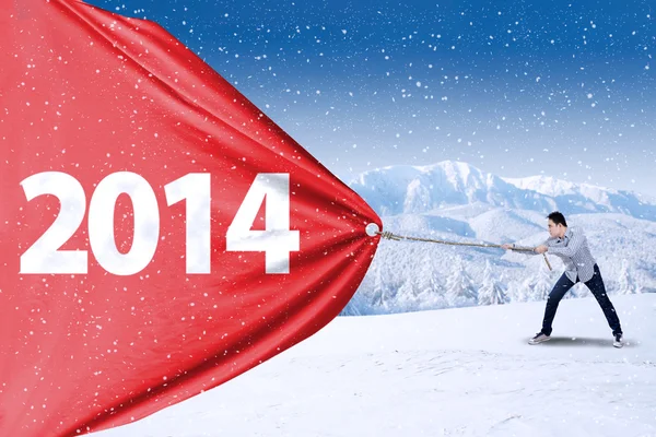 Young man pulling new year of 2014 — Stock Photo, Image