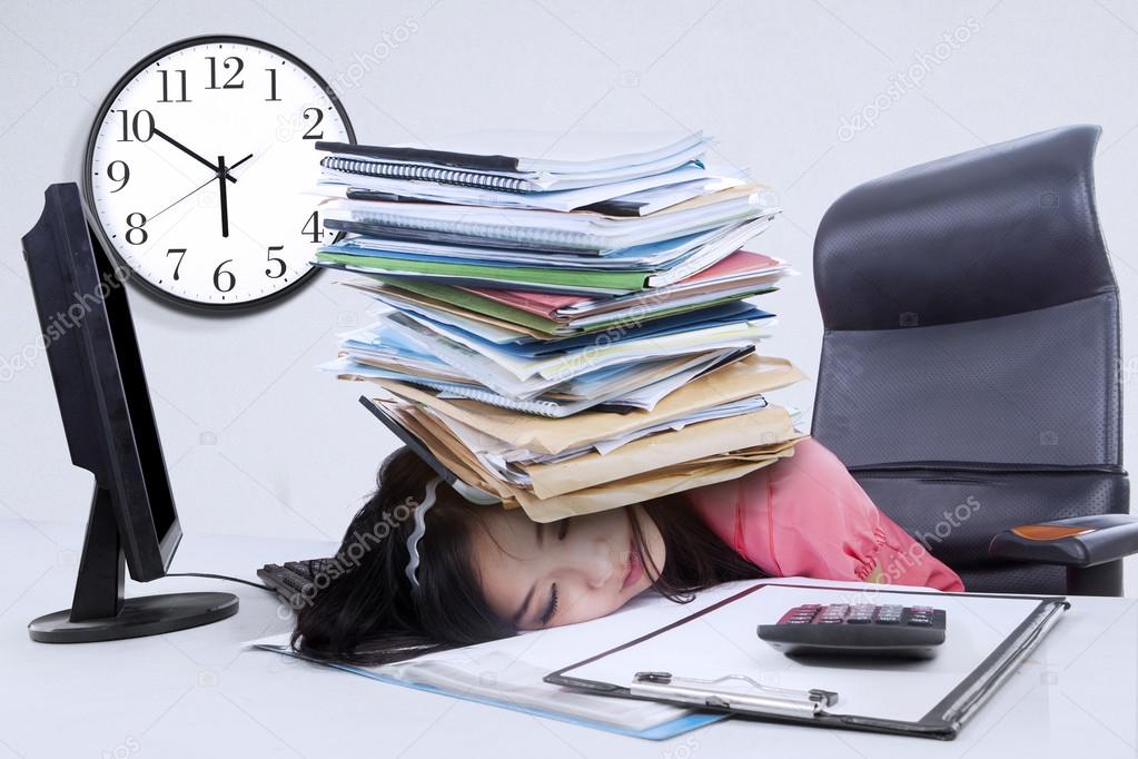 Tired woman with a pile of document