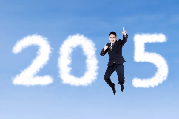 Businessman jumping to celebrate new year — Stock Photo, Image