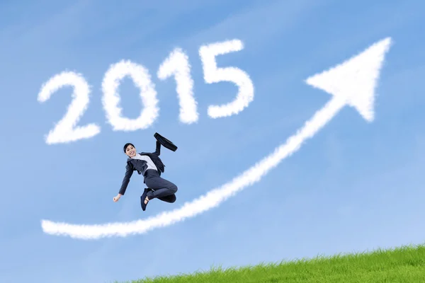 Business person leaping on meadow — Stock Photo, Image