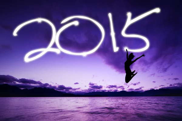 Woman jumping under number of 2015 — Stock Photo, Image