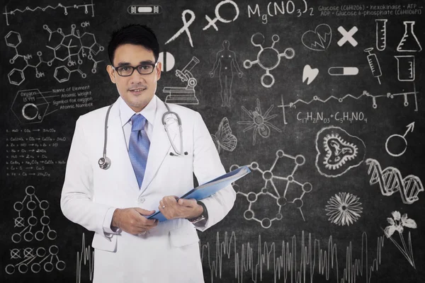 Doctor with doodle on the blackboard — Stock Photo, Image