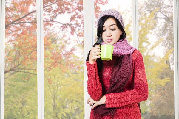 Girl blowing warm drink — Stock Photo, Image