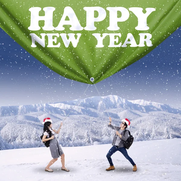 Hispanic students pulling new year banner — Stock Photo, Image