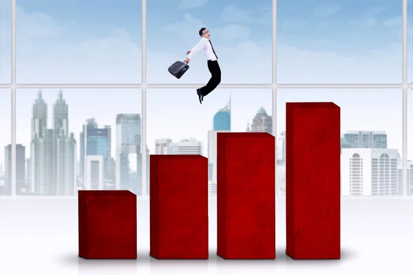 Businessman jumps above chart — Stock Photo, Image