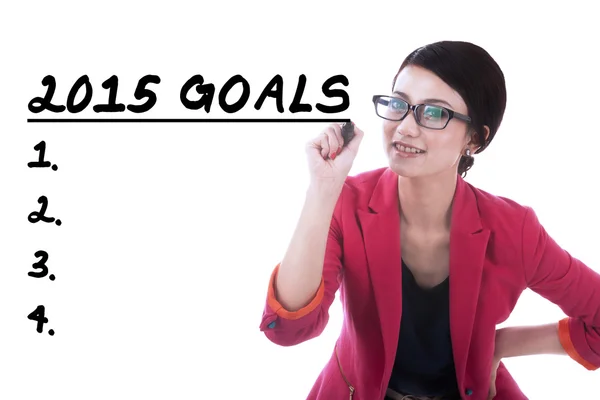 Female entrepreneur writes her goals — Stock Photo, Image