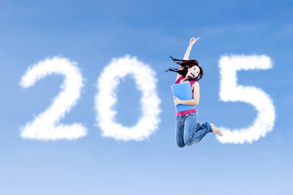 Female student jumps with number 2015 — Stock Photo, Image