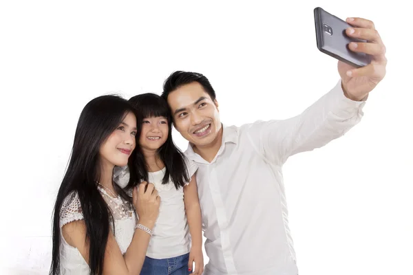 Hispanic family taking self portrait — Stock Photo, Image