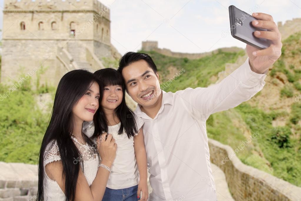 Happy family taking photo in Great Wall