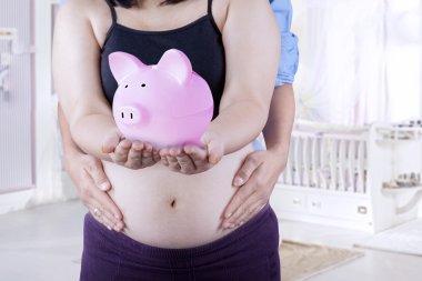 Pregnant woman showing moneybox clipart