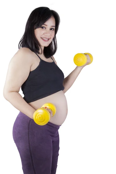 Pregnant woman exercises in studio — Stock Photo, Image
