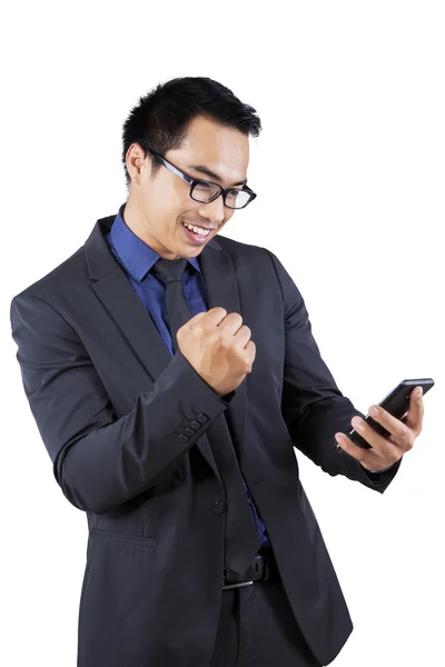 Satisfied businessman holding mobile phone — Stock Photo, Image