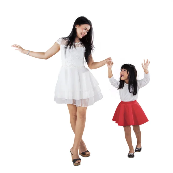 Joyful girl and her mother walk together Royalty Free Stock Images