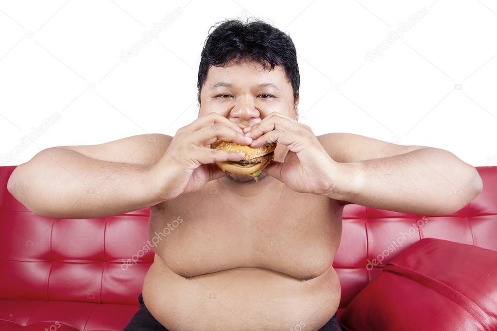 Hungry person eating burger