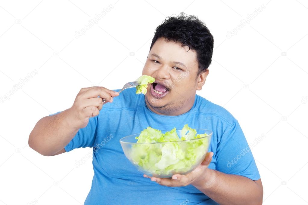 Man eat a bowl of salad