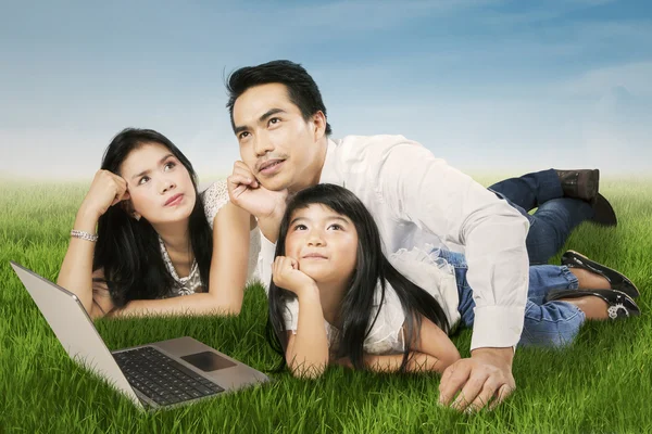 Happy family daydreaming outdoors — Stock Photo, Image