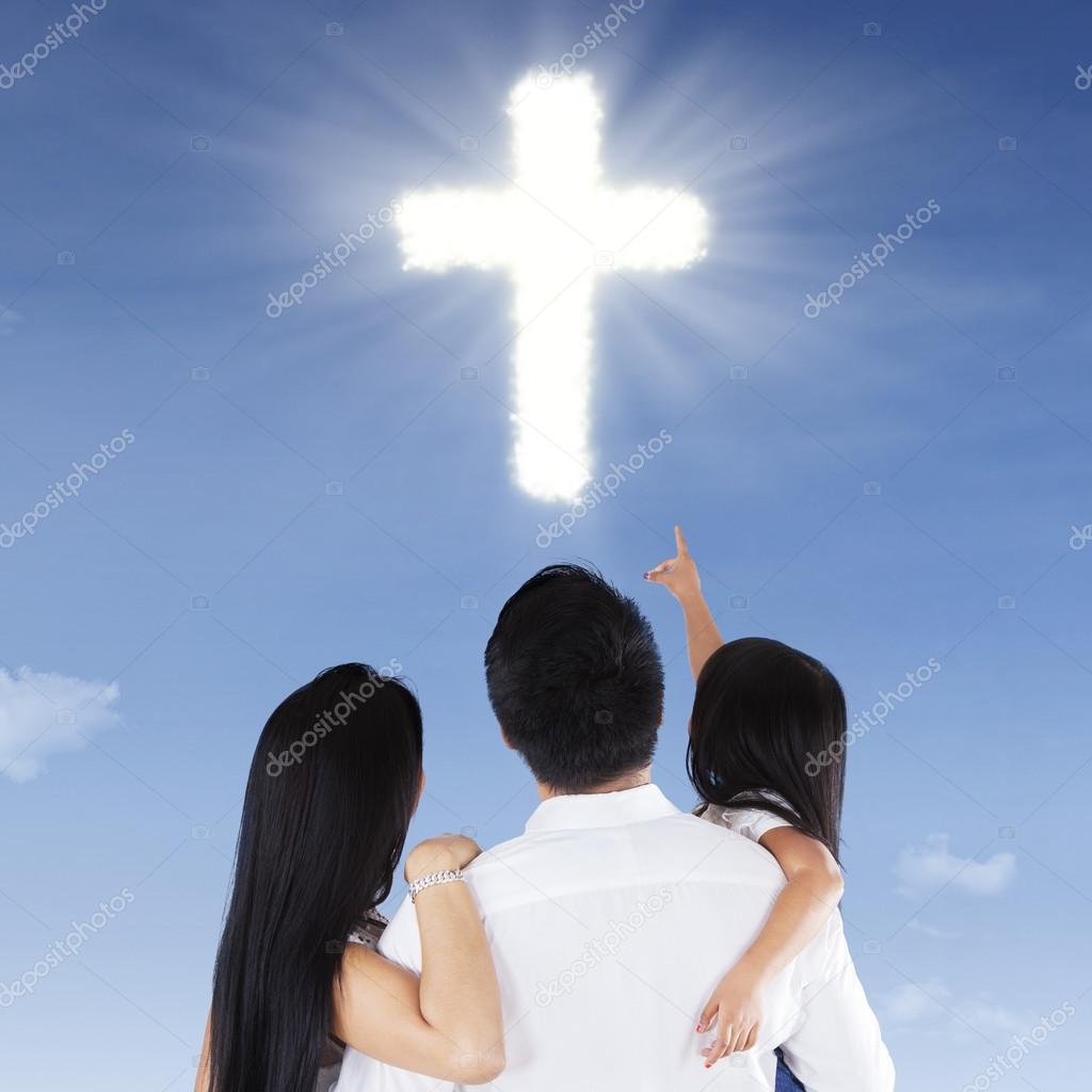 Family looking at a cross symbol
