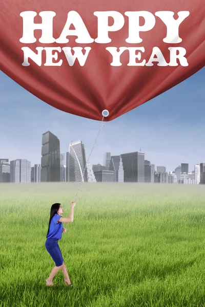 Woman and a banner of new year — Stock Photo, Image