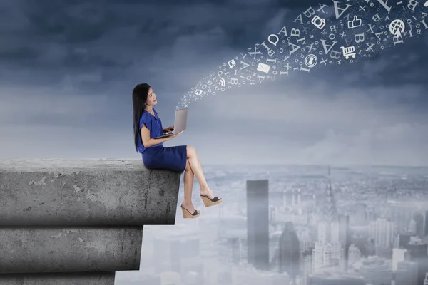 Woman sending information from rooftop — Stock Photo, Image