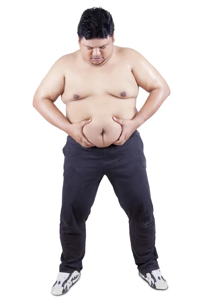 Pessoa com excesso de peso segura a barriga — Fotografia de Stock