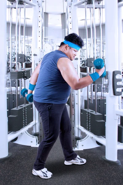 Overweight person exercise with barbells — Stock Photo, Image