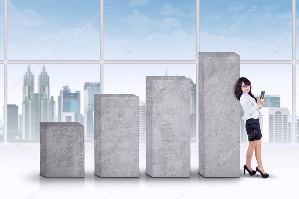 Successful businesswoman leans on bars
