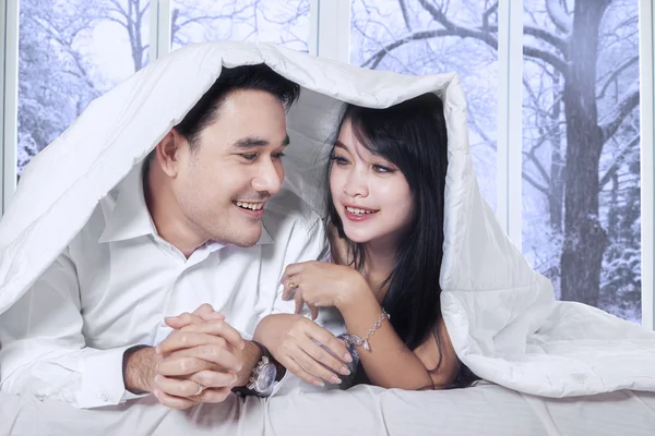 Couple enjoy winter day on bed — Stock Photo, Image