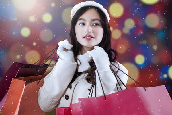 Chica con bolsas de compras y fondo desenfocado — Foto de Stock