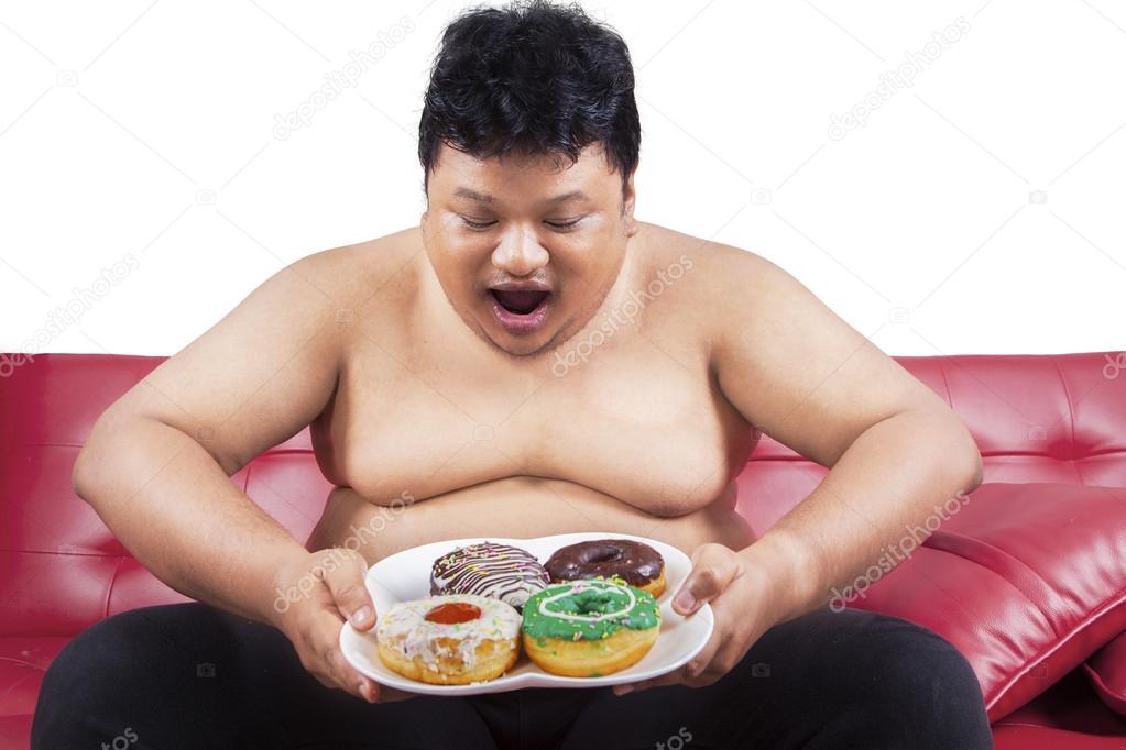Cheerful fat man looking at donuts 1