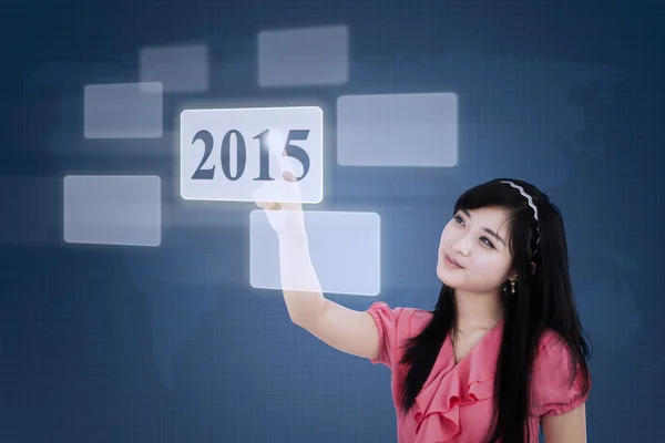 Female employee pressing number 2015 — Stock Photo, Image