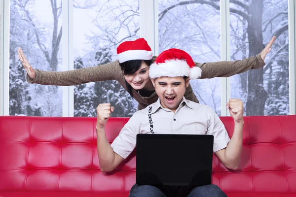 Casal satisfeito após pagar on-line no dia de Natal — Fotografia de Stock