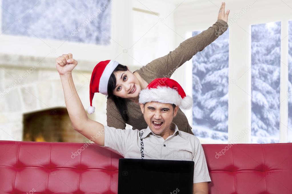 Couple prepare christmas by shopping online