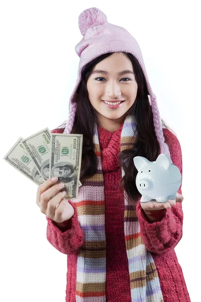 Girl with piggybank and dollar bills — Stock Photo, Image